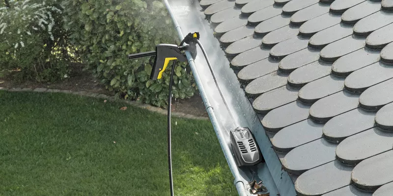 a person cleaning gutters